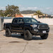 Dirt King 2.5 Coilovers DCA Remote Reservoir Toyota Tacoma in driveway, front-quarter view