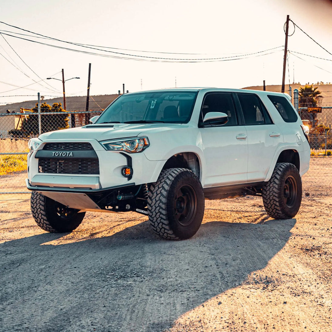 Dirt King Long Travel Kit Toyota white SUV, front-left view