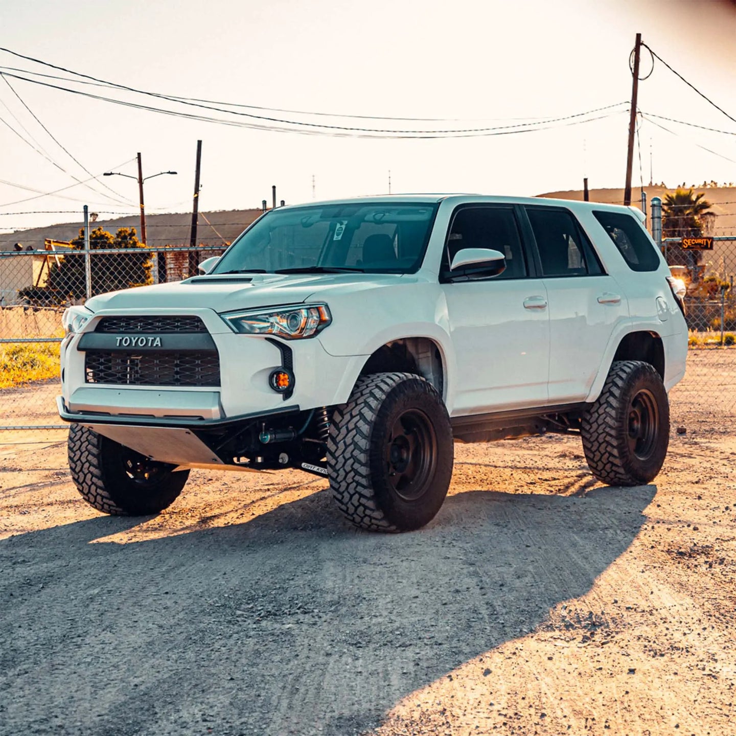 Dirt King Long Travel Kit Toyota white SUV, front-left view
