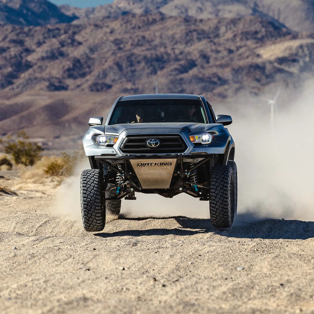 Long Travel Kit Dirt King for Toyota pickup — front suspension with blue shocks and steel skid plate