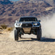 Long Travel Kit Dirt King for Toyota pickup — front suspension with blue shocks and steel skid plate