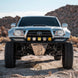 Long Travel Kit Toyota by Dirt King front-view off-road pickup with aftermarket bumper and LED light bar