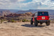 Artec JL Spare Tire Delete Kit Bare Aluminum for Jeep JL Wrangler, rear view on desert rocks, two Jeeps visible