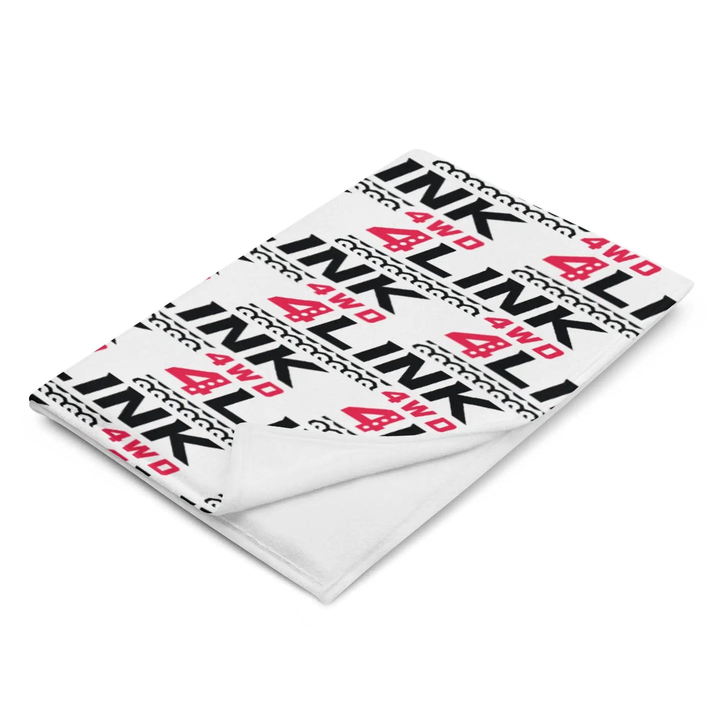 4Link4WD Throw Blanket white with repeating black 4WD pattern and red 4WD logo, folded corner visible
